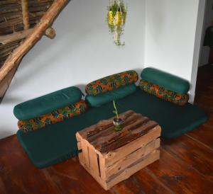 a green couch with a wooden box in a room at Lazy Beach House in Kiwengwa