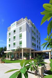 a large white building with trees in front of it at The Terrace Hotel in Nakhon Si Thammarat