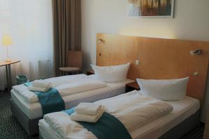 Postel nebo postele na pokoji v ubytování Check Inn Hotel Merseburg