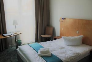 Postel nebo postele na pokoji v ubytování Check Inn Hotel Merseburg