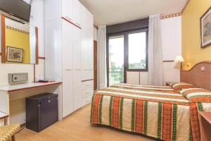 Postel nebo postele na pokoji v ubytování Hotel Harry's