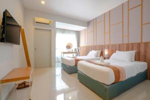 Postel nebo postele na pokoji v ubytování Hug Nimman Hotel