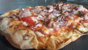 a pizza sitting on top of a table at B&B Le Caselle "Il Baraccotto" in Lucignano