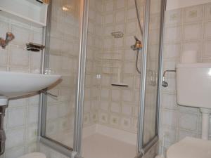 a bathroom with a shower and a sink and a toilet at Lona C 43 in Grimentz