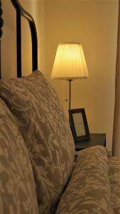 a bed with a lamp and a picture on a table at Double Key by HR in Amman +145 photos