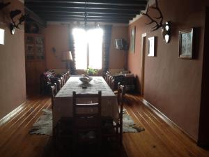 a dining room with a table and chairs and a window at Mas Vell in Catí +6 photos