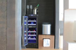 a refrigerator filled with lots of wine bottles at 鸛巣（ムカカヴィラ コウノス) in Nakijin