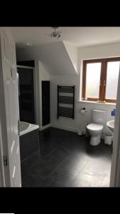 a bathroom with a toilet and a sink at The Anchorage B and B in John O Groats