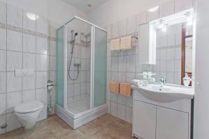 a bathroom with a shower and a toilet and a sink at Apartments Konta Vodice in Vodice +16 photos