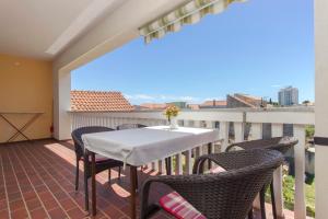 a patio with a table and chairs on a balcony at Apartments Konta Vodice in Vodice