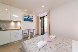 Posteľ alebo postele v izbe v ubytovaní Apartment Roso