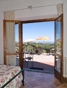 a bedroom with a view of a patio at B&B I Coppi in San Gimignano