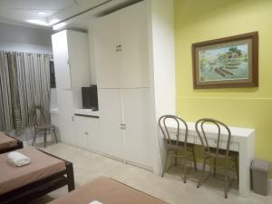 a living room with a table and two chairs at Royale House Hotel Davao powered by Cocotel in Tagum