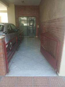 a garage with a car parked in front of a building at Elias Appartment in Volos