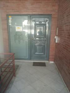 a large metal door in a brick building at Elias Appartment in Volos