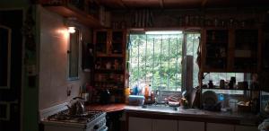 a kitchen with a sink and a window and a stove at Armonía y Naturaleza B&B Hostería Exclusiva in Tigre