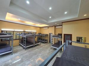 a room with rows of bunk beds in it at We Hostel Khaolak in Khao Lak