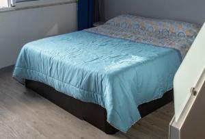 マシコにあるApartamento Goisの青い毛布が付いたベッドルームのベッド1台