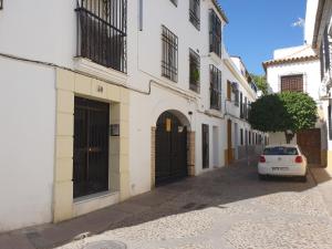 a car parked on a street next to a building at Vivienda Turística en la Muralla de San Basilio in Córdoba