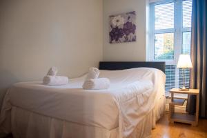 a bedroom with a white bed with towels on it at Windmill Lane in Dublin