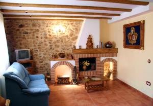 a living room with a couch and a fireplace at LA PORTAZA in Vera de Moncayo