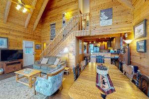 a living room with a staircase in a cabin at Kick Back Cabin in Pagosa Springs