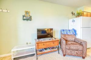 a living room with a chair and a table at Moosehead Condo Unit #5 in Rockwood