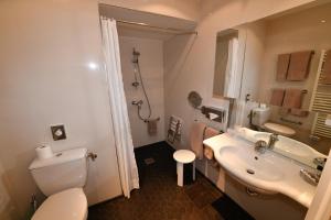 a bathroom with a white toilet and a sink at Hôtel de Provence in Cannes