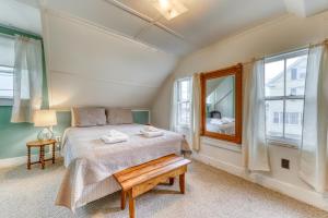 a bedroom with a bed and a large window at Cottage on the Cove in Wells