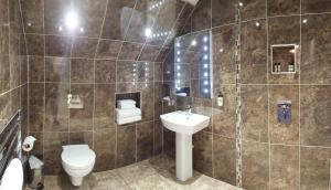 a bathroom with a toilet and a sink at The White Hart in Great Yeldham