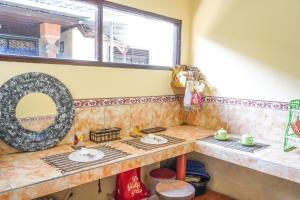 a kitchen with two counters and a window at BALI BAMBOO JUNGLE HUTS AND HOSTEL in Tampaksiring