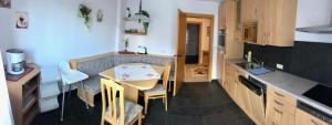 a small kitchen with a table and chairs in it at Ferienwohnung Schranz in Innsbruck