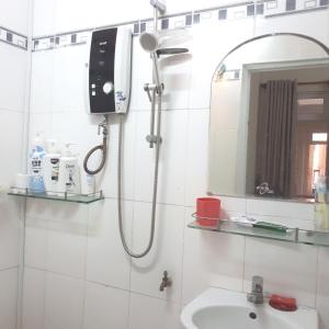 a bathroom with a shower and a sink and a mirror at Forget Me Not Hotel in Nha Trang