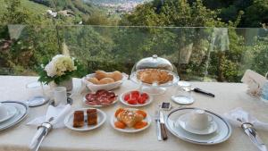 a table topped with plates of food on a table at Bed and Breakfast Isabella in Miane