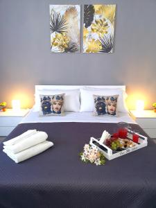 a bedroom with a bed with a tray of food on it at Casa Ibla in Siracusa