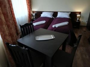 a room with two beds and a table with a laptop on it at Iglika 2, A6 in Borovets