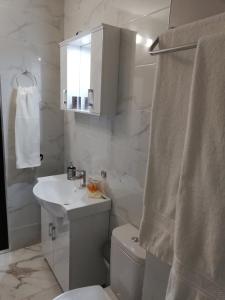 a bathroom with a sink and a toilet and a mirror at Iglika 2, A6 in Borovets