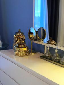 a dresser with gold mirrors and a mirror on it at Salty Stories in Ponta Delgada +24 photos