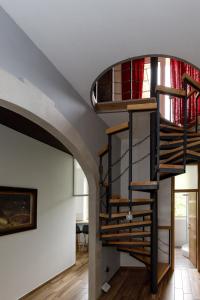 a spiral staircase in the living room of a house at Prenoćište Kastel in Knin