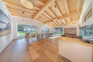 a large dining room with a table and chairs at Chalet Dumbria Dolomites in Selva di Val Gardena