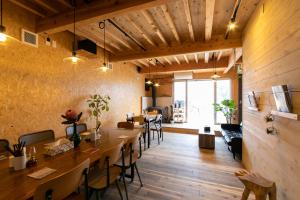 a restaurant with wooden floors and tables and chairs at 富士山も見える静かな港町用宗のオーシャンビューゲストハウスRomey in Shizuoka