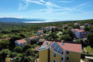a house with solar panels on the roof at Apartments Salatić in Krk