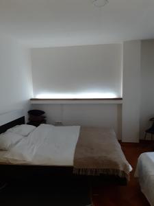 a bedroom with a white bed and a window at Blue New Yorker in Niš