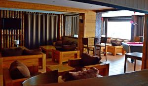 a living room with couches and chairs and a television at Le Terril Blanc in Tignes