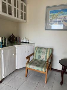 a chair sitting in a room with a counter at Beach Vue Barbados in Bridgetown
