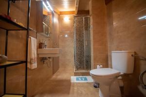 a bathroom with a toilet and a sink and a shower at Soffitta Luminosa in Preveza +34 photos
