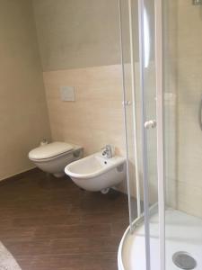 a bathroom with a toilet and a sink and a shower at Casa Costa Outlet 4 in Serravalle Scrivia +24 photos