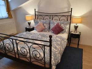 A bed or beds in a room at Karmelita Boutique Apartman