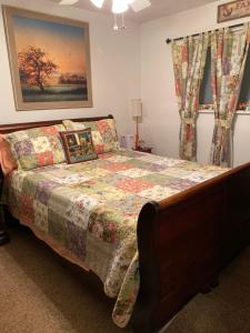 a bedroom with a bed with a quilt on it at Our Home, Your Home in Black Mountain