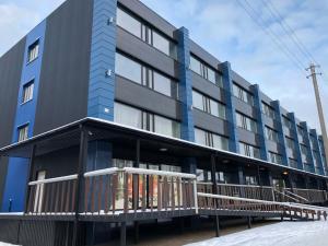 a blue building with a balcony in the snow at Hostel Laurita in Kaunas